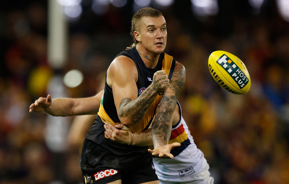 AFL 2016 Rd 03 - Richmond v Adelaide MELBOURNE, AUSTRALIA - APRIL 9: Dustin Martin of the Tigers handpasses the ball during the 2016 AFL Round 03 match between the Richmond Tigers and the Adelaide Crows at the Etihad Stadium, Melbourne on April 9, 2016. (Photo by Michael Willson/AFL Media)